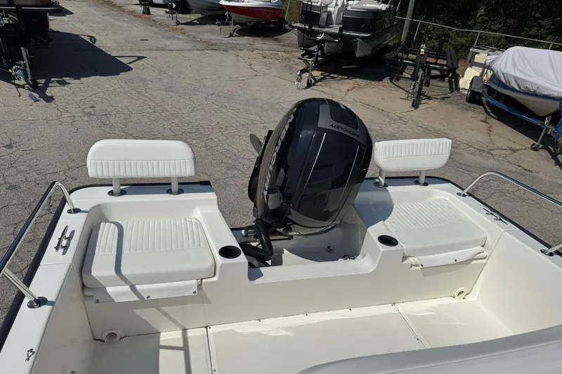 Slide: The Image of 2014 Boston Whaler 210 Montauk boat with Mercury outboard motor, docked on a sunny day. - 18