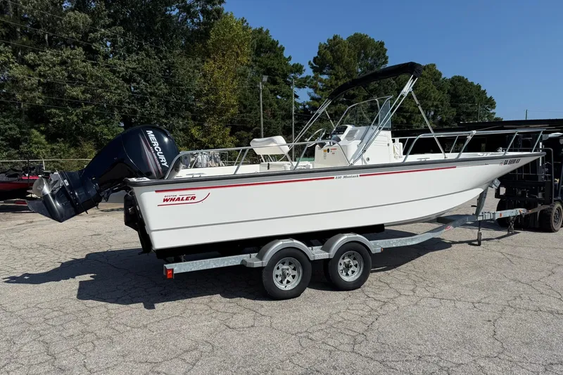 Slide: The Image of 2014 Boston Whaler 210 Montauk boat on trailer with Mercury outboard motor. - 2