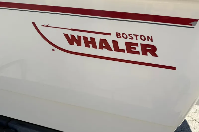 Slide: The Image of 2014 Boston Whaler 210 Montauk boat logo in red on white hull. - 23