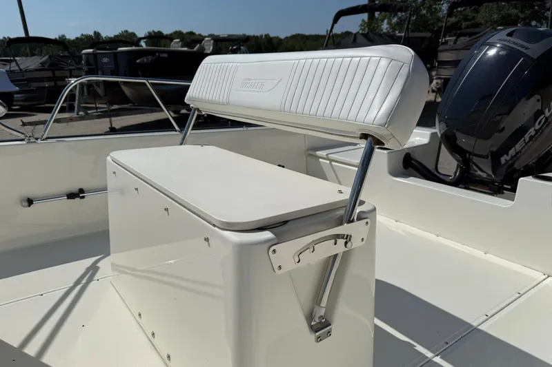 Slide: The Image of 2014 Boston Whaler 210 Montauk boat interior with seating and Mercury engine. - 7