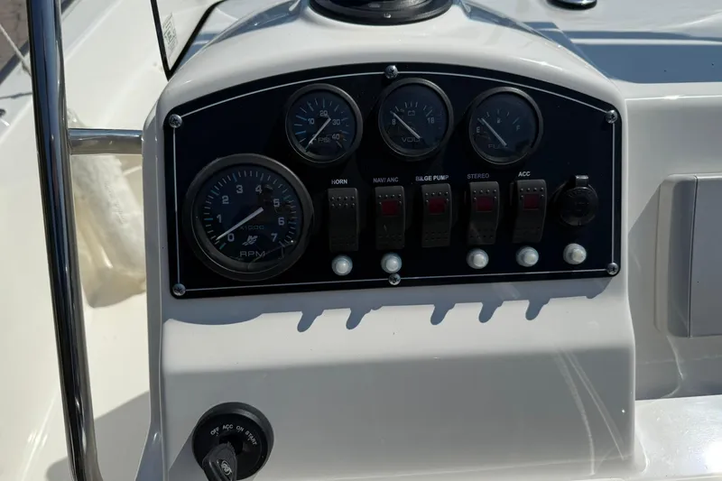 Slide: The Image of 2014 Boston Whaler 210 Montauk dashboard with gauges and control switches. - 9