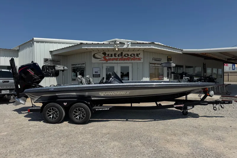 Slide: The Image of 2026 Phoenix 21XE boat parked outside Outdoor Specialties store. - 1