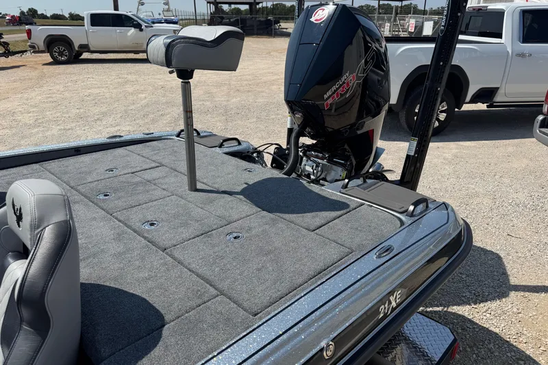 Slide: The Image of 2026 Phoenix 21XE boat with Mercury Pro XS engine, parked outdoors. - 10