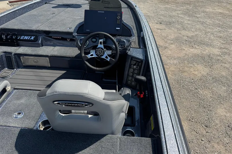 Slide: The Image of 2026 Phoenix 21XE boat interior with steering wheel, dashboard, and seating. - 5