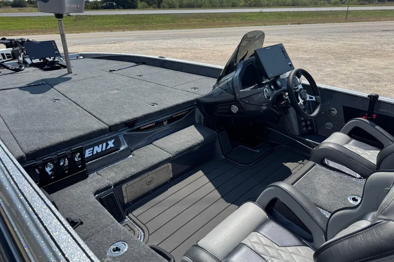 Slide: The Image of 2026 Phoenix 21XE boat interior with modern dashboard and seating. - 9