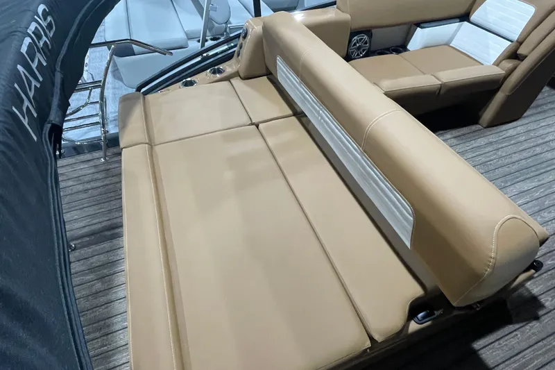 Slide: The Image of 2026 Harris Solstice 230 boat interior with tan seating and wood flooring. - 7