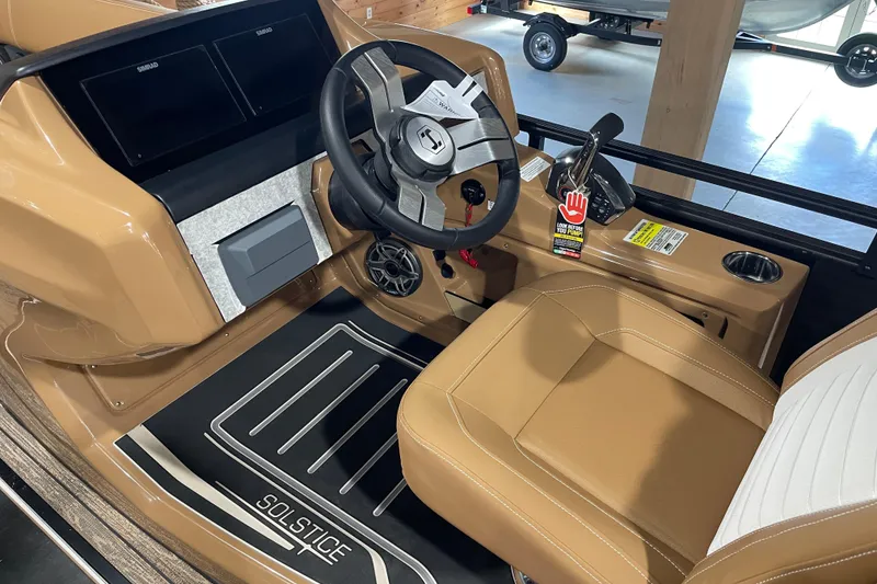 Slide: The Image of 2026 Harris Solstice 230 boat interior with tan seating and modern dashboard controls. - 9