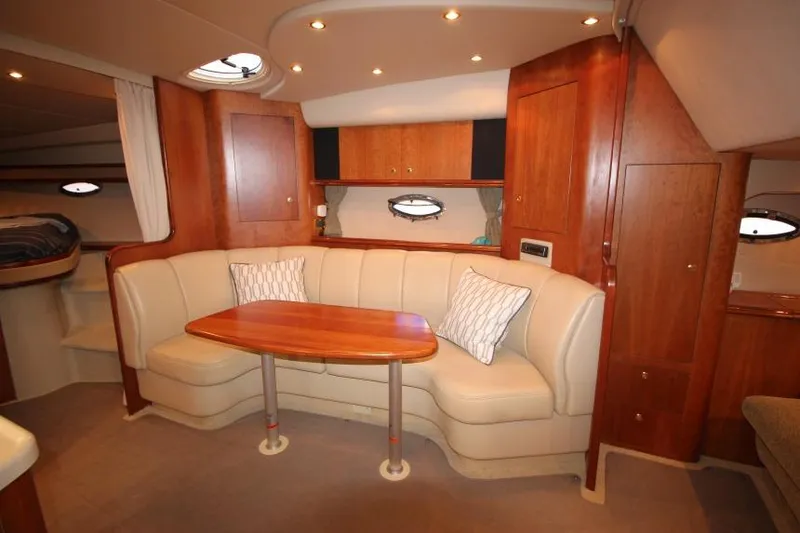 Slide: The Image of Interior of 2000 Cruisers Yachts 3672 Express with elegant seating and wooden cabinetry. - 15