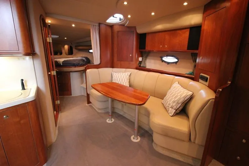 Slide: The Image of Luxurious interior of 2000 Cruisers Yachts 3672 Express with elegant seating and wood finishes. - 16
