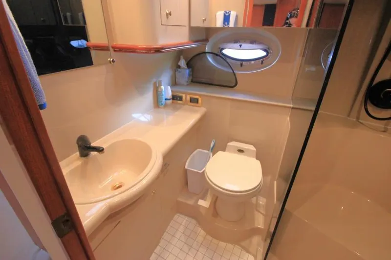 Slide: The Image of Bathroom interior of 2000 Cruisers Yachts 3672 Express, featuring sink, toilet, and shower. - 17