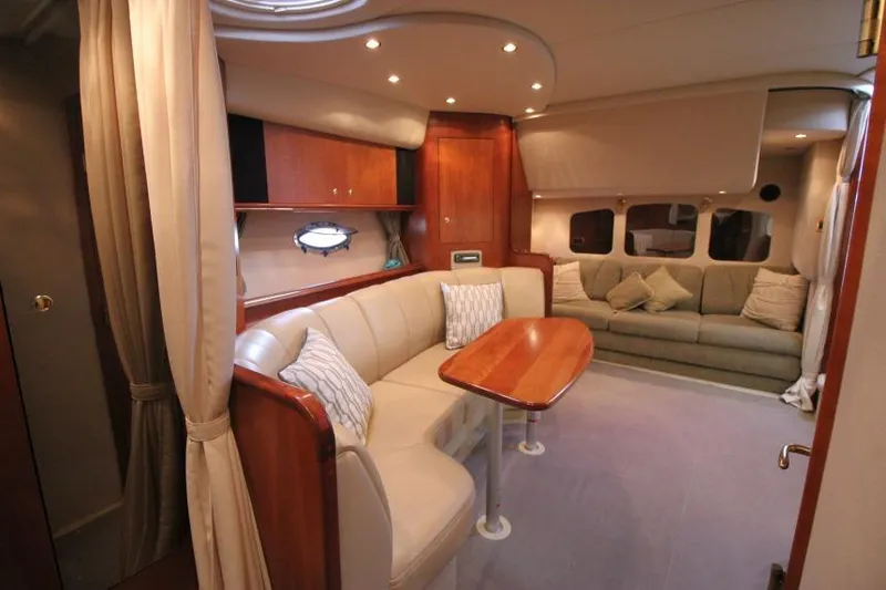 Slide: The Image of Luxurious interior of 2000 Cruisers Yachts 3672 Express with elegant seating and wooden accents. - 21