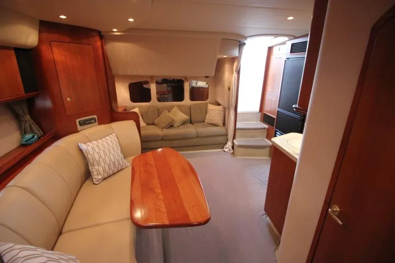 Slide: The Image of Interior of 2000 Cruisers Yachts 3672 Express with cozy seating and wooden finishes. - 22