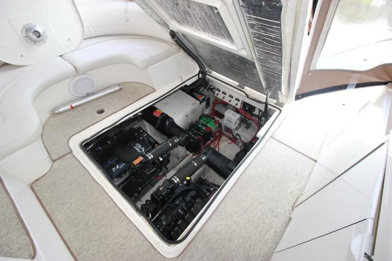 Slide: The Image of Engine compartment of 2000 Cruisers Yachts 3672 Express, showcasing mechanical components and wiring. - 23