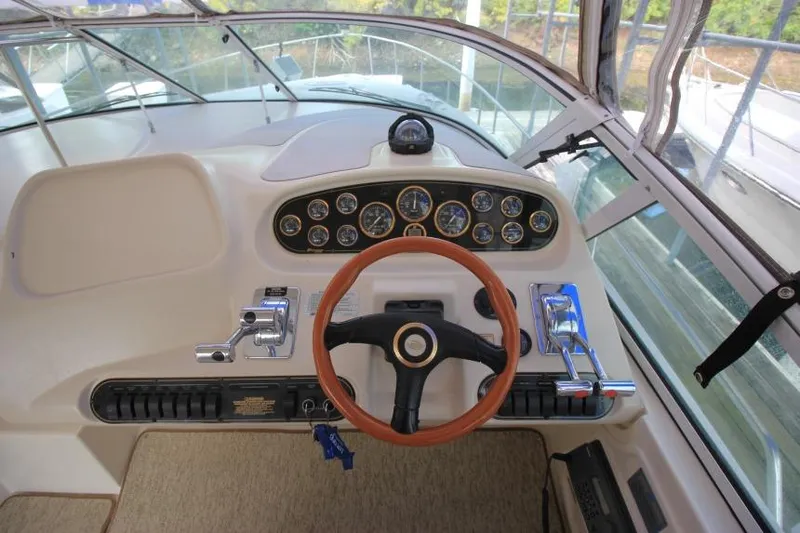 Slide: The Image of Cockpit of 2000 Cruisers Yachts 3672 Express with steering wheel and control panel. - 10