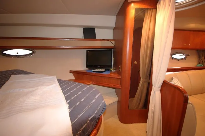 Slide: The Image of Interior of 2000 Cruisers Yachts 3672 Express with cozy cabin and TV setup. - 20