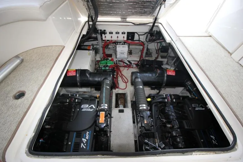 Slide: The Image of Engine compartment of 2000 Cruisers Yachts 3672 Express, featuring dual V8 engines. - 24