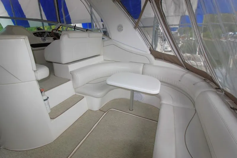 Slide: The Image of Interior of 2000 Cruisers Yachts 3672 Express with white seating and table. - 4