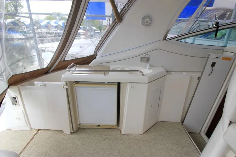Slide: The Image of 2000 Cruisers Yachts 3672 Express interior with kitchenette and sink. - 5