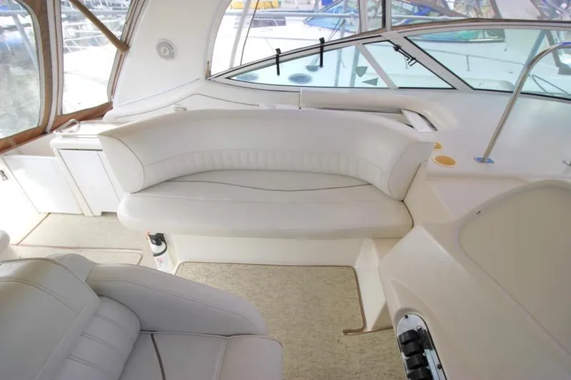 Slide: The Image of Interior of 2000 Cruisers Yachts 3672 Express with white seating and helm area. - 8