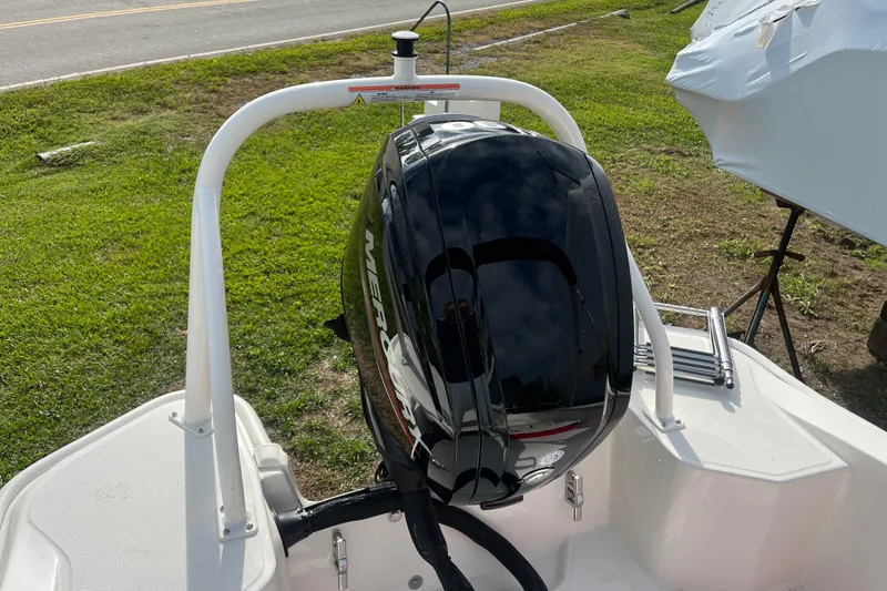 Slide: The Image of 2024 Boston Whaler 160 Super Sport with Mercury outboard engine, parked on grass. - 12