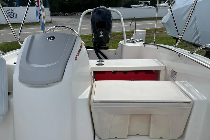 Slide: The Image of 2024 Boston Whaler 160 Super Sport boat interior with seating and motor view. - 4