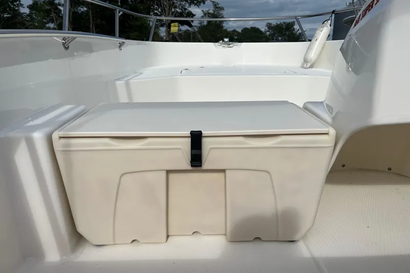 Slide: The Image of 2024 Boston Whaler 160 Super Sport interior with storage compartment and seating. - 9