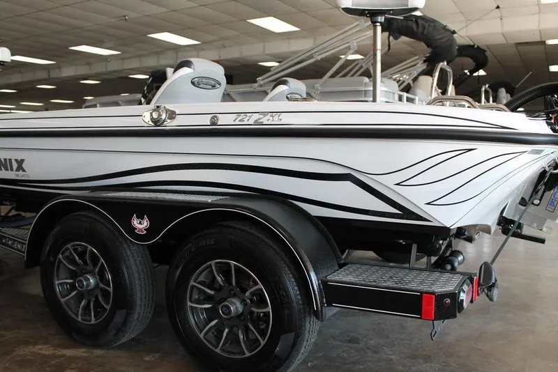 Slide: The Image of 2026 Phoenix 721 ZXL boat on trailer, sleek design, indoor showroom setting. - 8