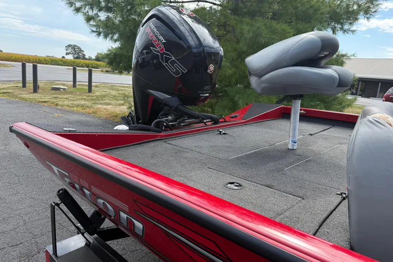 Slide: The Image of 2018 Triton 18 TX boat with Mercury Pro XS engine, red exterior, and gray seating. - 11