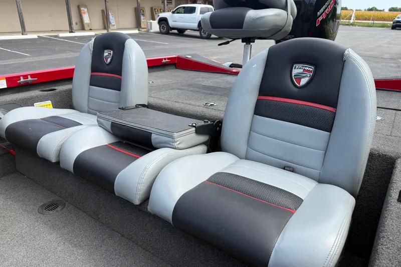 Slide: The Image of 2018 Triton 18 TX boat interior with gray and black seating, red accents. - 15