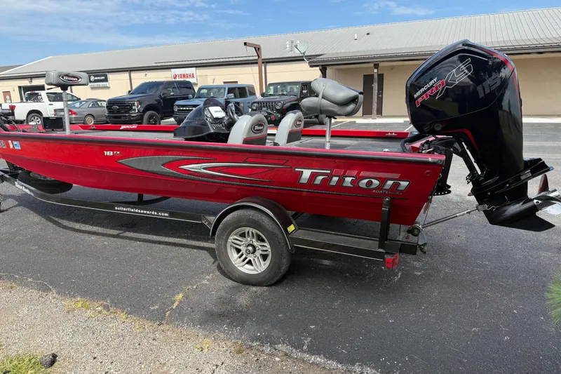 Slide: The Image of Red 2018 Triton 18 TX boat with Mercury Pro XS engine on trailer. - 3