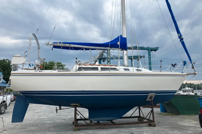Slide: The Image of 1989 Catalina 30 MkII sailboat on dry dock with blue and white hull. - 4