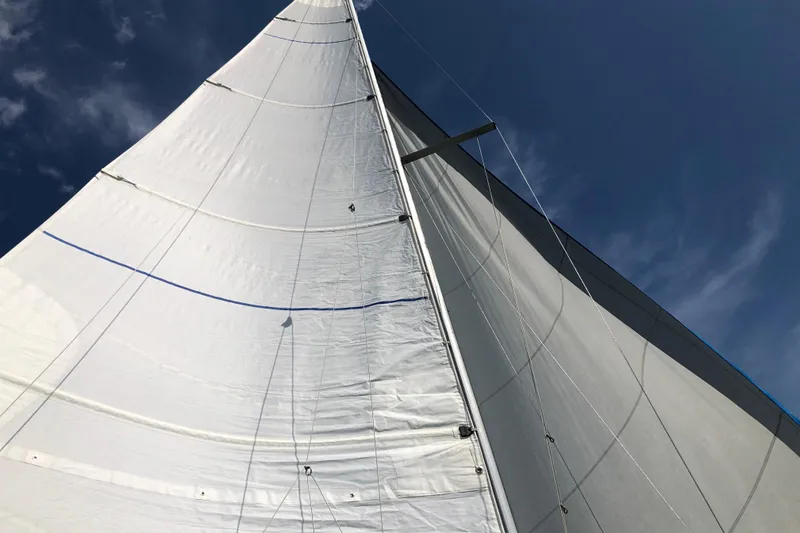 Slide: The Image of Sails of a 1989 Catalina 30 MkII yacht against a clear blue sky. - 5