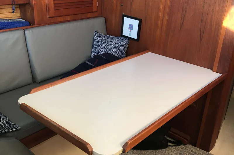 Slide: The Image of Interior of 1989 Catalina 30 MkII sailboat with wooden table and cushioned seating. - 8