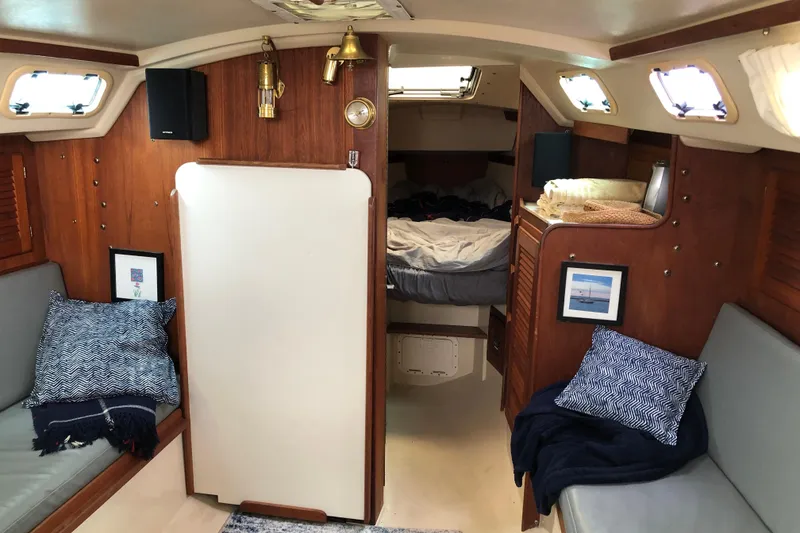 Slide: The Image of Interior of 1989 Catalina 30 MkII sailboat with cozy seating and nautical decor. - 9