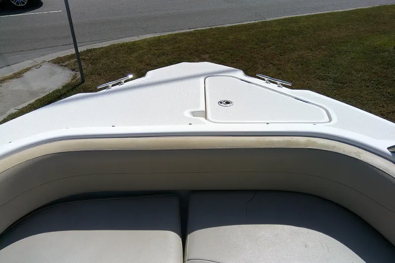 Slide: The Image of 2015 Pursuit DC 235 Dual Console boat bow with seating and storage compartment. - 10