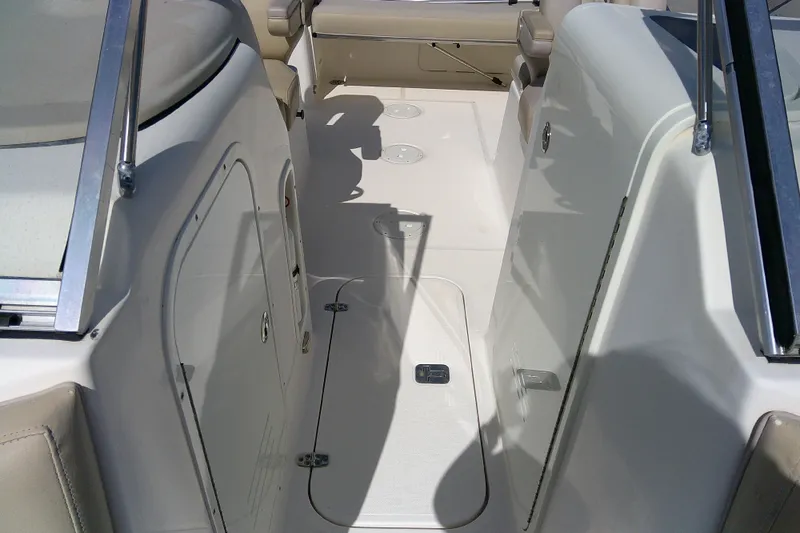 Slide: The Image of 2015 Pursuit DC 235 Dual Console boat interior with seating and storage compartments. - 11