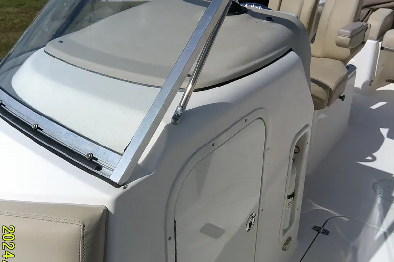 Slide: The Image of 2015 Pursuit DC 235 Dual Console boat interior with seating and windshield. - 12