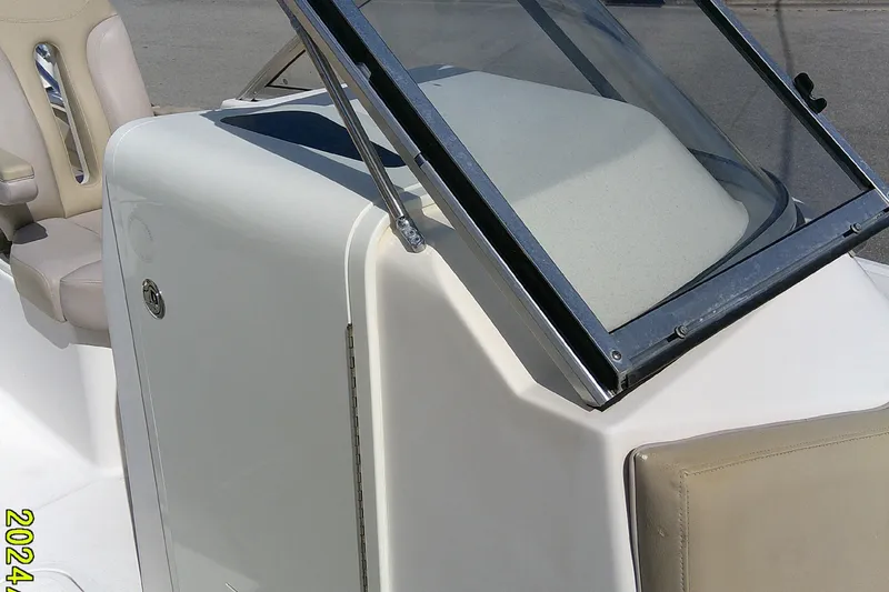Slide: The Image of 2015 Pursuit DC 235 Dual Console boat windshield and seating detail. - 13