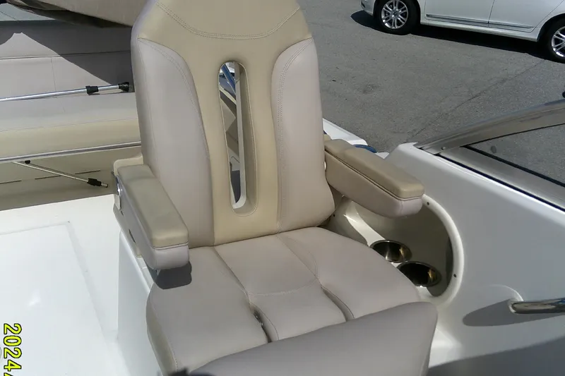 Slide: The Image of 2015 Pursuit DC 235 Dual Console boat seat with armrests and cup holders. - 16