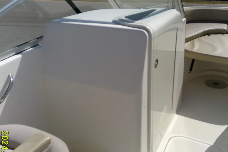 Slide: The Image of 2015 Pursuit DC 235 Dual Console interior with seating and storage compartment. - 18