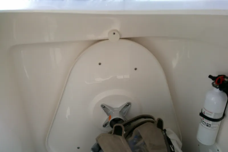 Slide: The Image of 2015 Pursuit DC 235 Dual Console interior with fire extinguisher and storage area. - 21