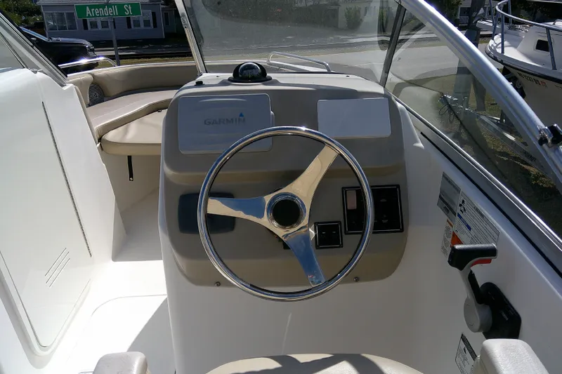 Slide: The Image of 2015 Pursuit DC 235 Dual Console boat dashboard with Garmin navigation system. - 22