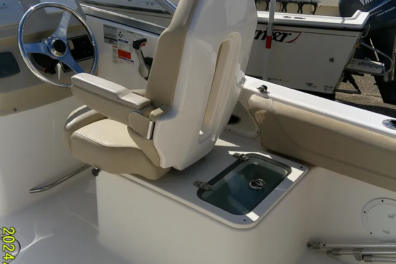 Slide: The Image of 2015 Pursuit DC 235 Dual Console boat interior with steering wheel and seating. - 25