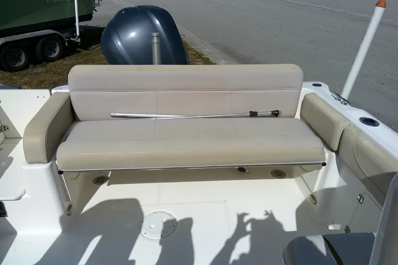 Slide: The Image of 2015 Pursuit DC 235 Dual Console boat with beige seating and rod holder. - 29