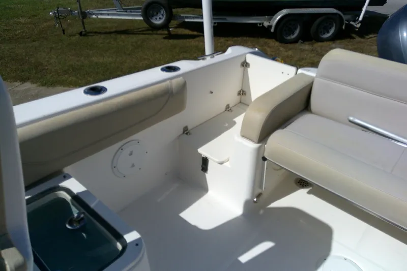 Slide: The Image of 2015 Pursuit DC 235 Dual Console boat interior with seating and storage. - 30