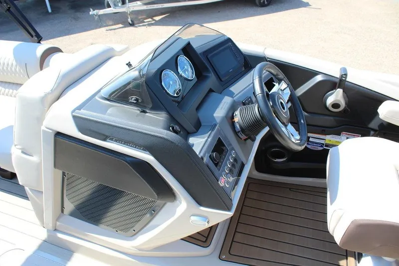 Slide: The Image of 2026 Avalon Catalina Quad Lounger Shift 25 FT boat dashboard with steering wheel and controls. - 14