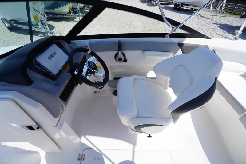 Slide: The Image of Interior of 2026 Chaparral 21 SSi OB boat with steering wheel and white seating. - 15