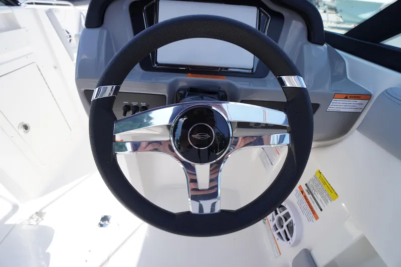 Slide: The Image of Steering wheel of 2026 Chaparral 21 SSi OB boat, featuring sleek design and controls. - 16