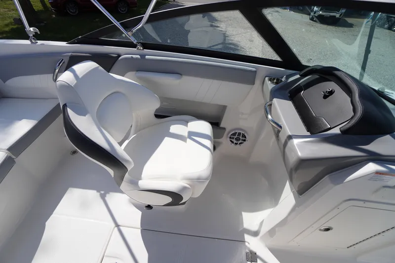 Slide: The Image of 2026 Chaparral 21 SSi OB boat interior with white seating and dashboard. - 20