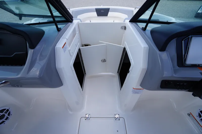 Slide: The Image of 2026 Chaparral 21 SSi OB boat interior with open storage compartments. - 21